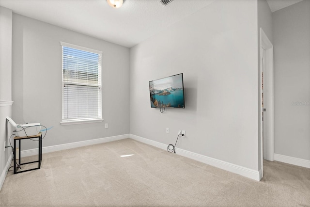 unfurnished living room with carpet floors and baseboards