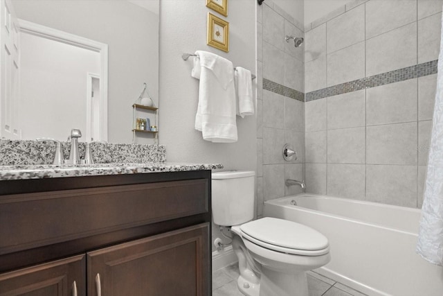 bathroom with toilet, vanity, and washtub / shower combination