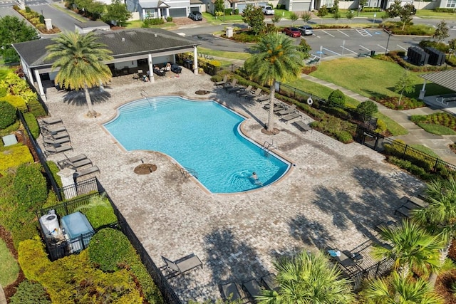 community pool featuring fence and a patio area