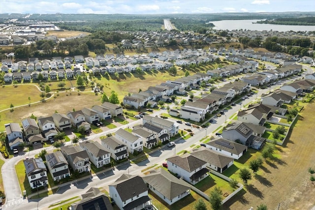 aerial view of property's location with nearby suburban area and a large body of water