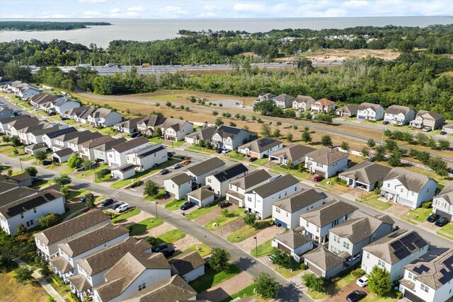 aerial view of residential area featuring a nearby body of water