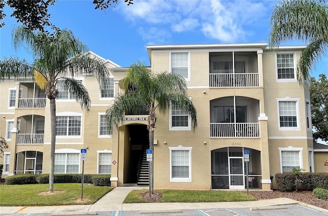 2302 Butterfly Palm Way Unit 105, Kissimmee, FL 34747 - view of building exterior with uncovered parking