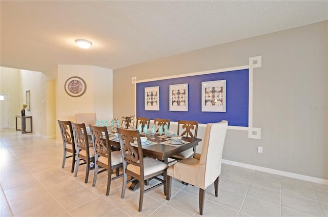 dining room featuring light tile patterned floors and baseboards