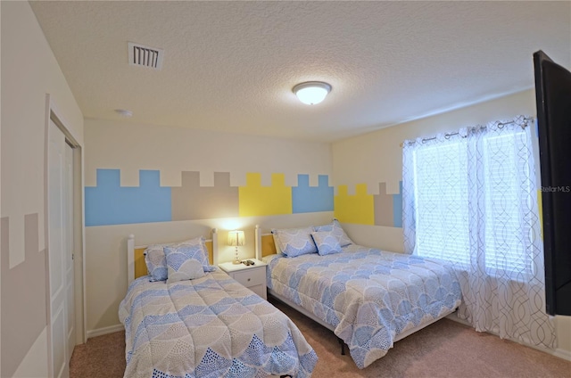 carpeted bedroom featuring a textured ceiling