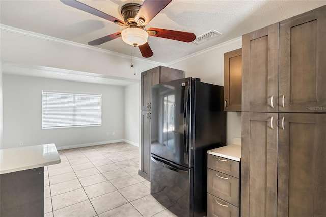1051 Arden St, Longwood, FL 32750 - kitchen with light tile patterned flooring, ceiling fan, light countertops, freestanding refrigerator, and visible vents