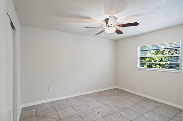 1051 Arden St, Longwood, FL 32750 - spare room featuring baseboards, a ceiling fan, a textured ceiling, and light tile patterned floors