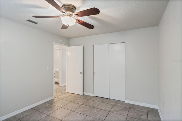 1051 Arden St, Longwood, FL 32750 - unfurnished bedroom with a ceiling fan, a textured ceiling, visible vents, light tile patterned floors, and a closet