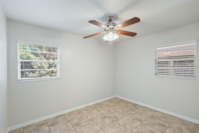 1051 Arden St, Longwood, FL 32750 - unfurnished room with light tile patterned floors, baseboards, ceiling fan, and a textured ceiling