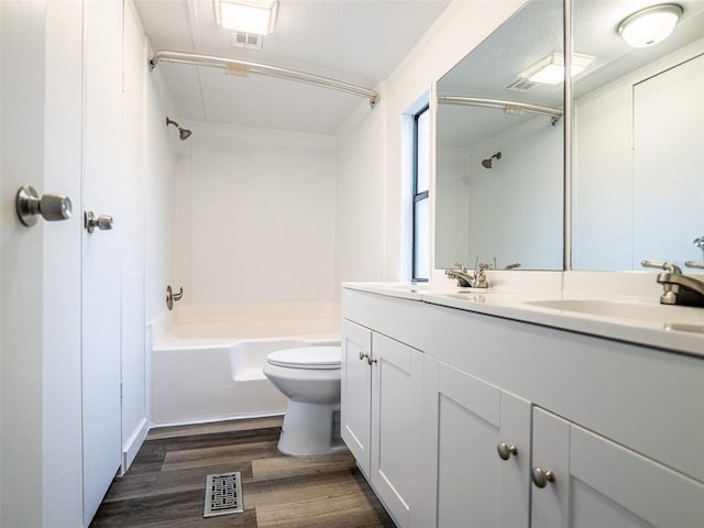 full bath featuring wood finished floors, toilet, shower / tub combination, a sink, and visible vents