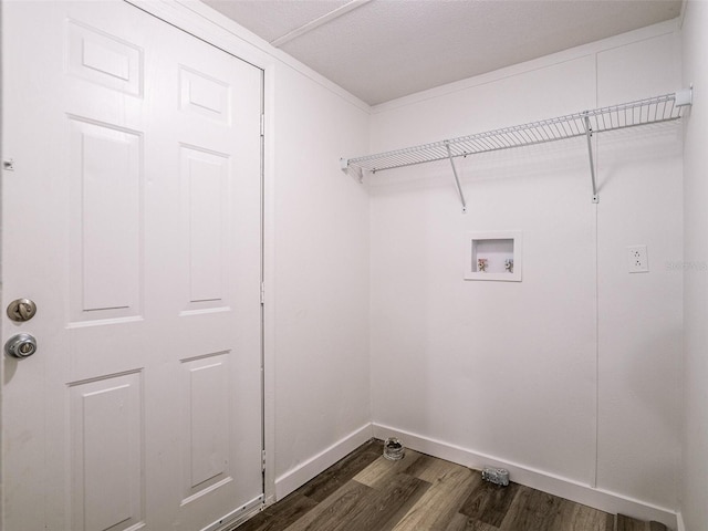 washroom with hookup for a washing machine, baseboards, laundry area, and dark wood finished floors