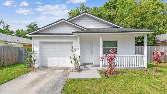 view of front of home featuring covered porch, fence, driveway, and a garage