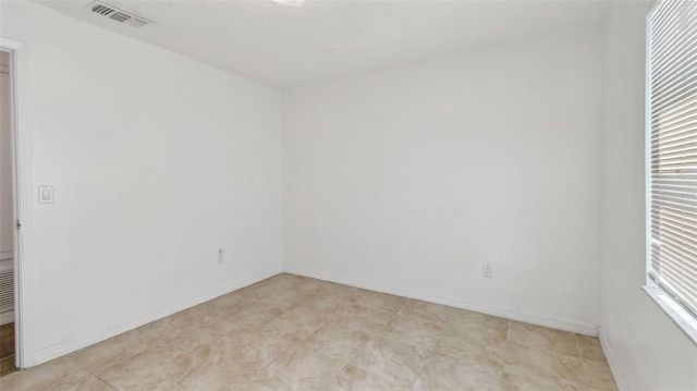 spare room with visible vents and baseboards
