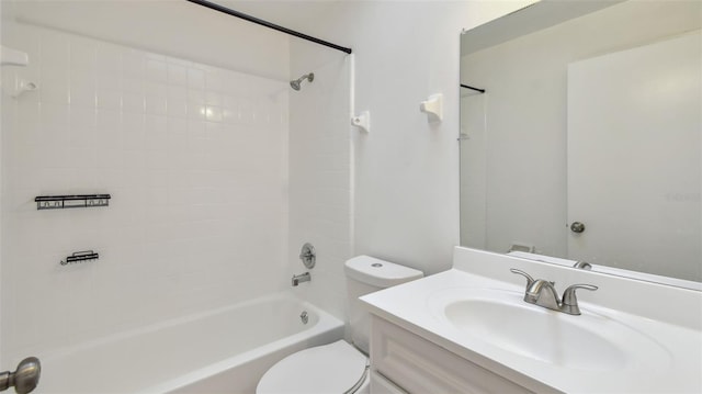 bathroom featuring washtub / shower combination, toilet, and vanity