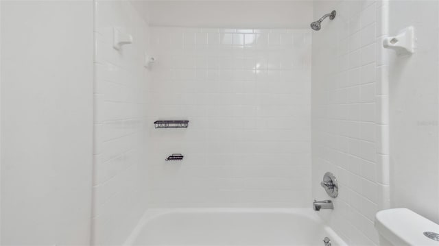 bathroom featuring toilet and shower / bath combination