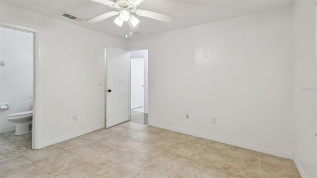 unfurnished bedroom featuring visible vents, ensuite bath, and baseboards