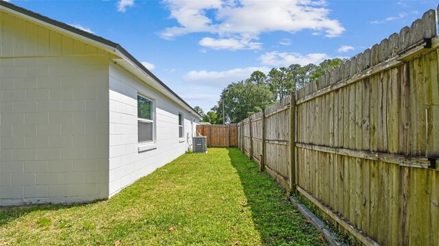 view of yard featuring a fenced backyard and central AC unit