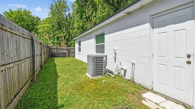 view of yard featuring central AC and a fenced backyard