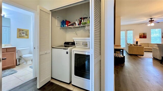 washroom with washer and dryer, a ceiling fan, laundry area, and light wood-type flooring