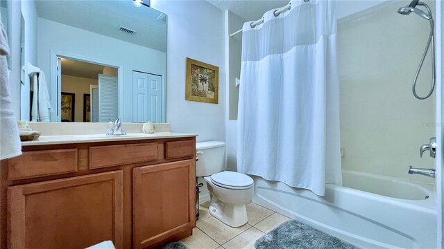bathroom with tile patterned flooring, vanity, shower / bath combo with shower curtain, toilet, and visible vents
