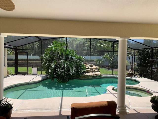 view of pool with a patio, a pool with connected hot tub, and a lanai