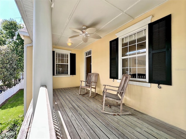 wooden deck featuring fence, covered porch, and a ceiling fan