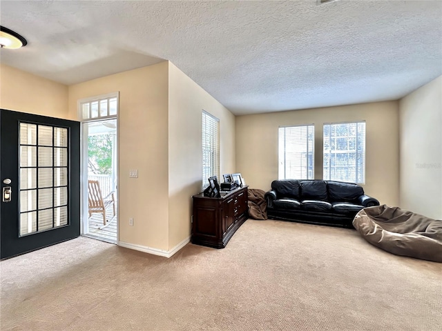 carpeted living room featuring baseboards