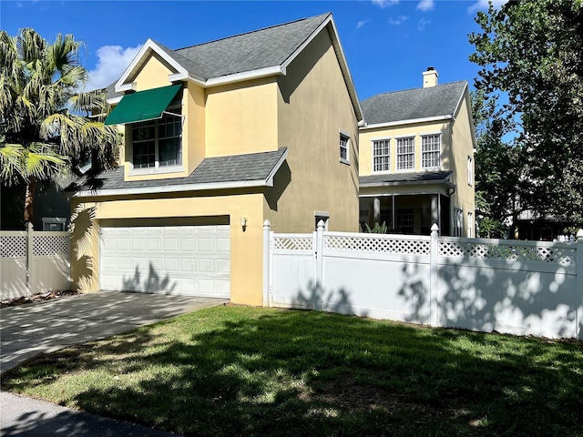 view of side of property with driveway, fence, a chimney, an attached garage, and stucco siding