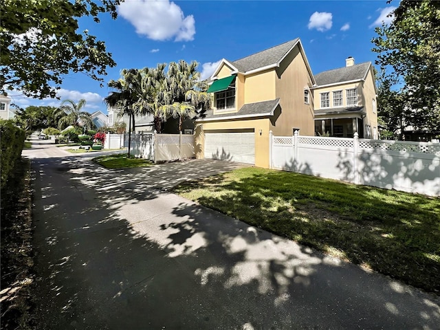 view of property exterior with fence, concrete driveway, stucco siding, and a garage