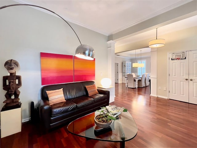 living area with ornamental molding, decorative columns, wood finished floors, and baseboards