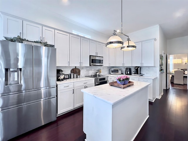 kitchen featuring white cabinets, appliances with stainless steel finishes, dark wood-style flooring, decorative light fixtures, and backsplash