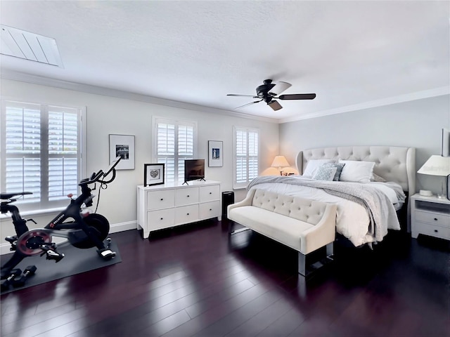 bedroom with dark wood-style floors, ornamental molding, and multiple windows