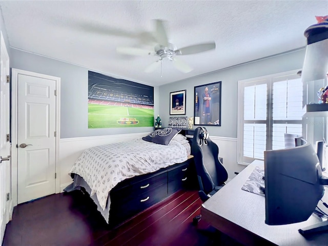 bedroom with a wainscoted wall and a ceiling fan