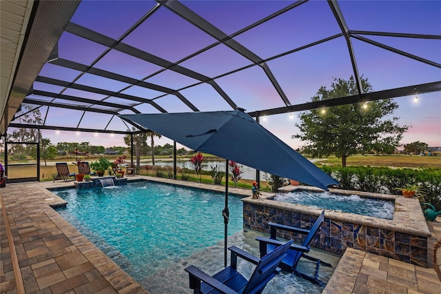 pool at dusk with a patio, a lanai, and a pool with connected hot tub