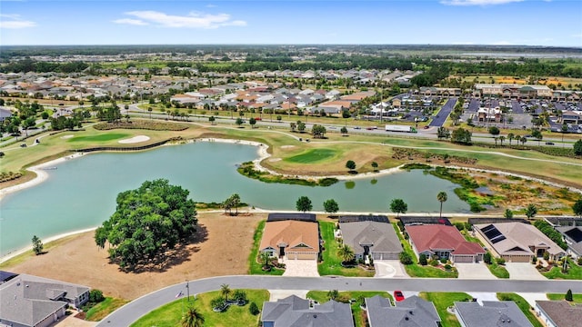 drone / aerial view with a residential view, a water view, and view of golf course