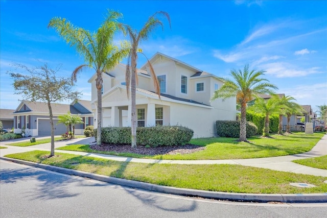 view of side of property with stucco siding, driveway, a yard, and a garage