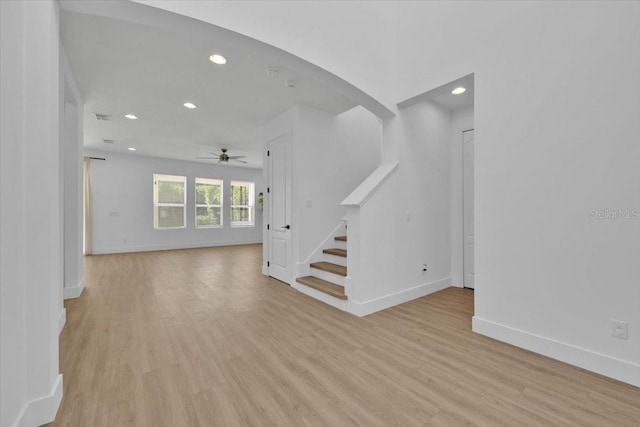 interior space featuring stairway, ceiling fan, baseboards, recessed lighting, and light wood finished floors
