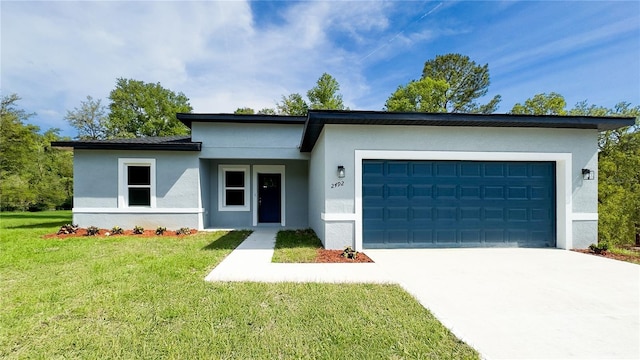 view of front of property featuring a front lawn, stucco siding, driveway, and an attached garage