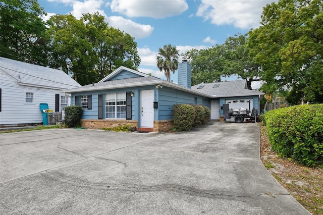 1239 E Ridgewood St, Orlando, FL 32803 - single story home with a garage, fence, a chimney, brick siding, and driveway