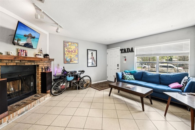 1239 E Ridgewood St, Orlando, FL 32803 - living room featuring track lighting, a brick fireplace, and a textured ceiling
