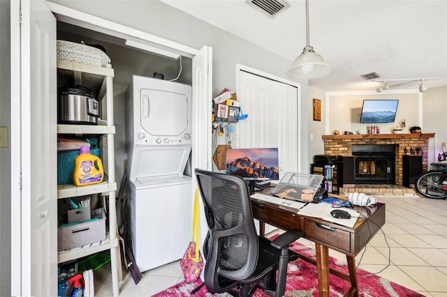 1239 E Ridgewood St, Orlando, FL 32803 - office space featuring light tile patterned floors, a brick fireplace, stacked washer and dryer, and visible vents