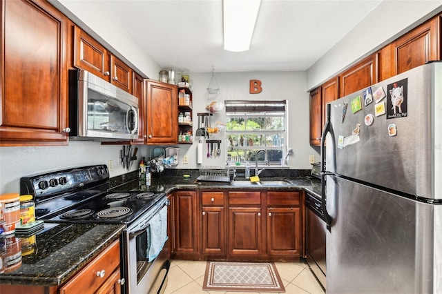 1239 E Ridgewood St, Orlando, FL 32803 - kitchen featuring a sink, dark stone countertops, appliances with stainless steel finishes, and light tile patterned flooring