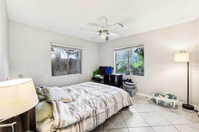 1239 E Ridgewood St, Orlando, FL 32803 - tiled bedroom with a ceiling fan and baseboards
