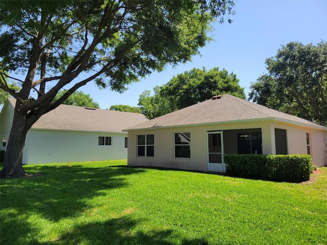 3586 Eversholt St, Clermont, FL 34711 - back of house with a yard and stucco siding