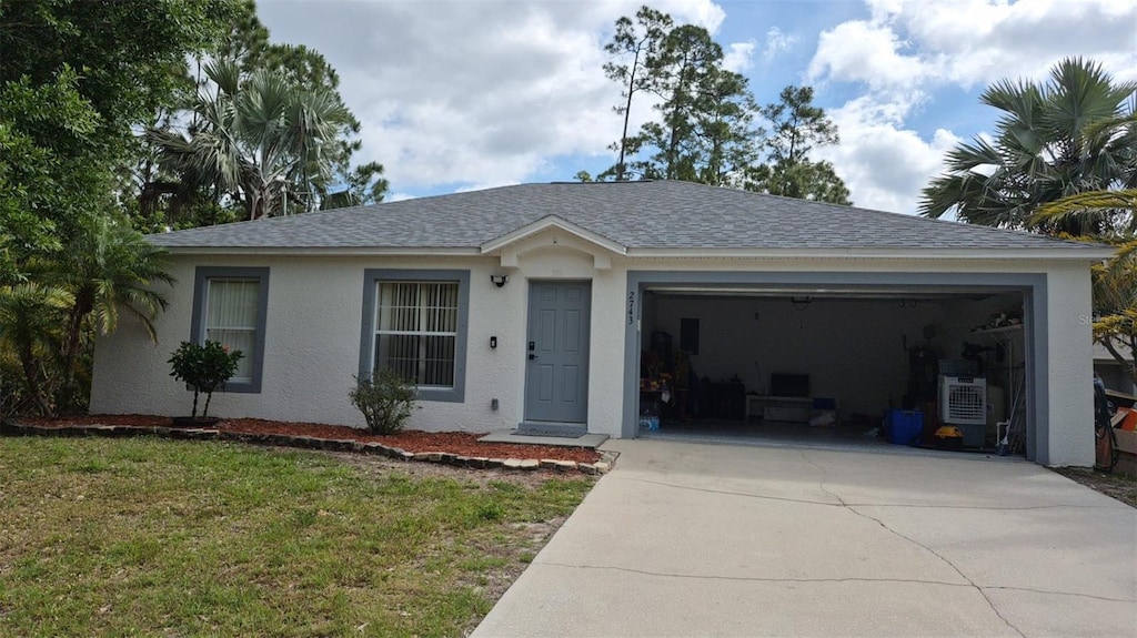 ranch-style house with stucco siding, driveway, roof with shingles, a front lawn, and an attached garage