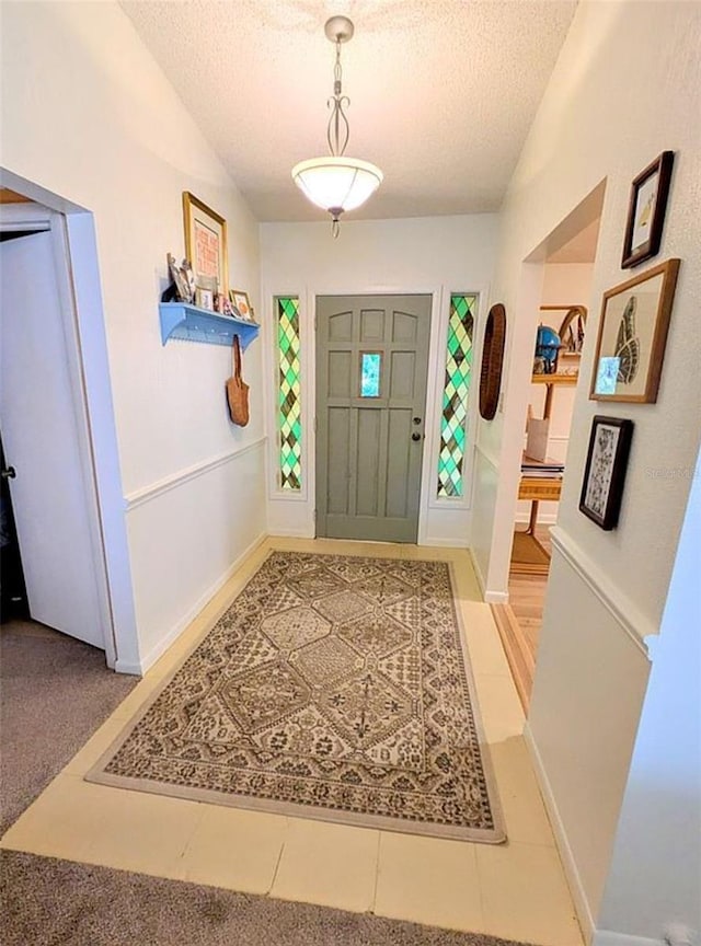 600 Lake St, Fruitland Park, FL 34731 - foyer entrance featuring a textured ceiling, baseboards, and light tile patterned flooring
