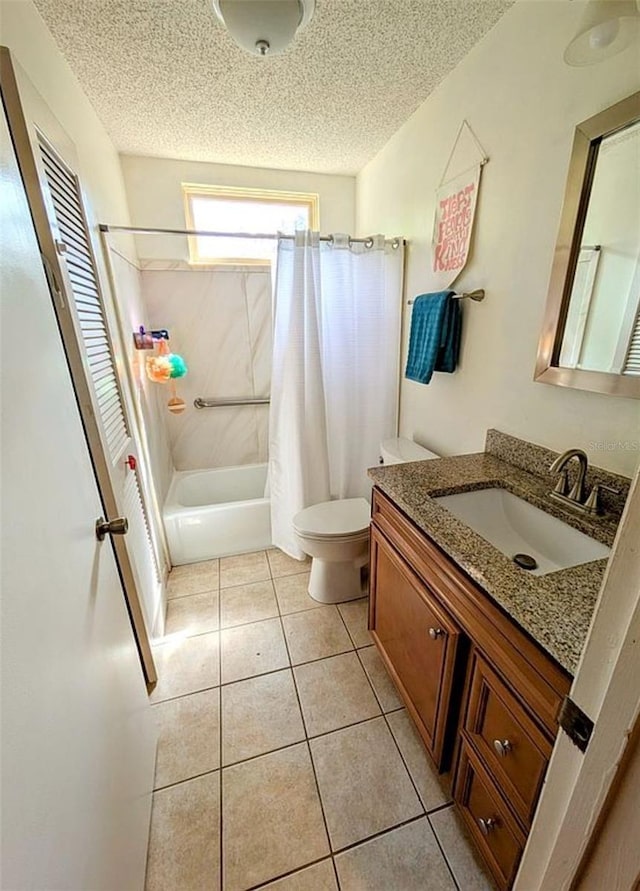 600 Lake St, Fruitland Park, FL 34731 - bathroom featuring toilet, tile patterned flooring, vanity, and a textured ceiling