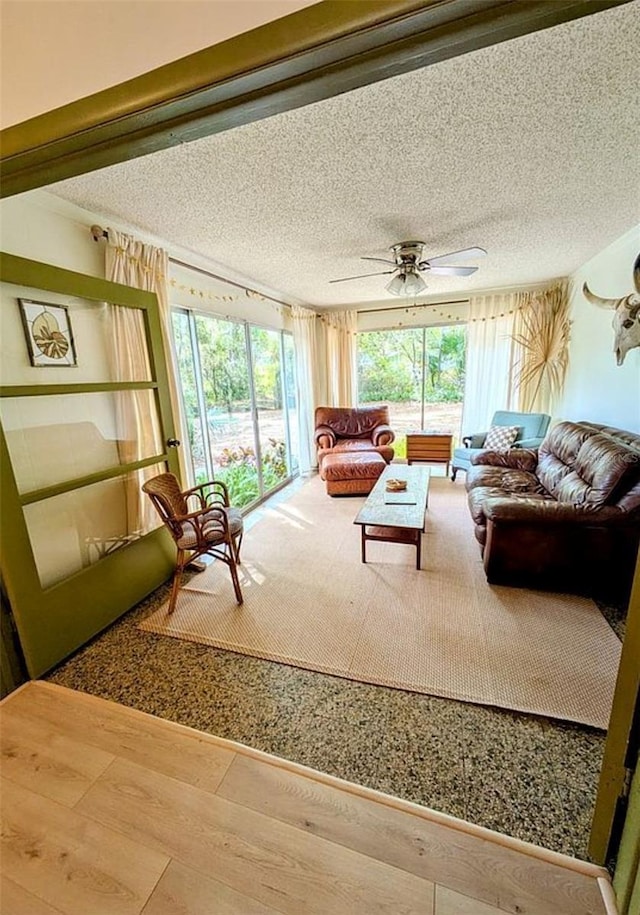 600 Lake St, Fruitland Park, FL 34731 - living room with a textured ceiling, wood finished floors, and a ceiling fan