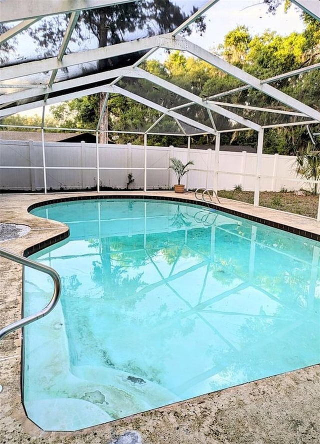 600 Lake St, Fruitland Park, FL 34731 - view of swimming pool with a fenced in pool, glass enclosure, and a fenced backyard