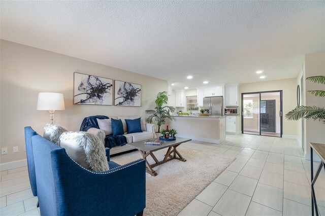 living area with baseboards, recessed lighting, light tile patterned floors, and a textured ceiling