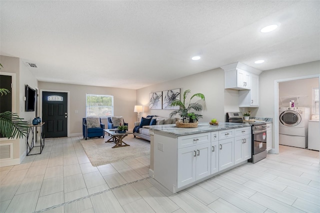 kitchen with light stone counters, white cabinetry, visible vents, stainless steel range with electric stovetop, and recessed lighting